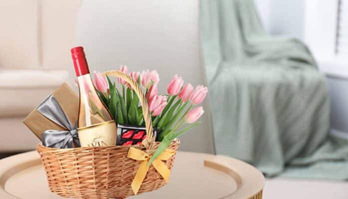 A beautifully curated London hamper featuring a bottle of wine, chocolates, and tulips, ideal for personal gifting or special occasions.