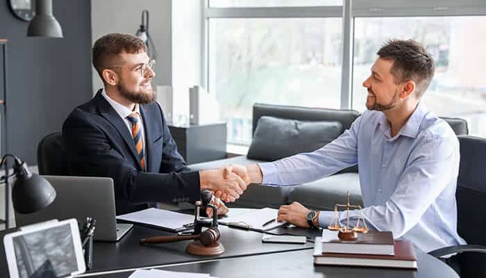 A client shaking hands with an attorney from GA Eminent Domain Law Firm, symbolizing trust and partnership in navigating eminent domain cases for fair compensation