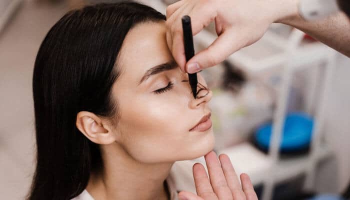 Choosing Rhinoplasty Surgery illustrated by facial assessment and nose marking before cosmetic nose surgery.