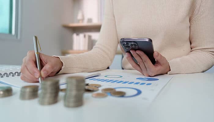 Year-Round Financial Strategy shown by analyzing budgets, tracking expenses, and managing cash flow with financial documents and coins.