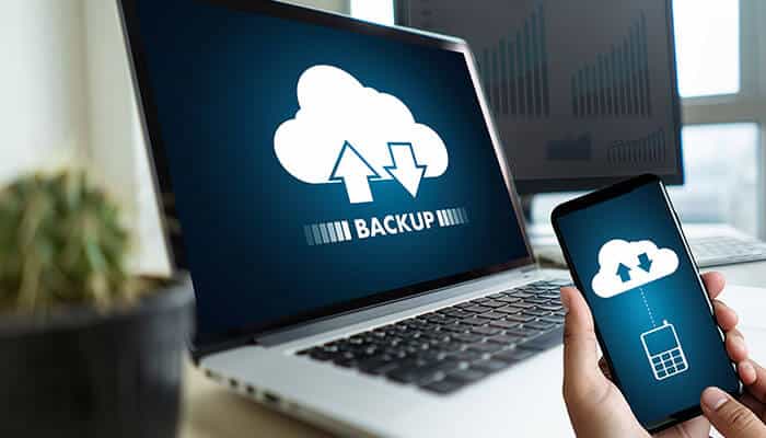 Restore from Backup - Startupeditor | Startup Editor A laptop with a cloud icon displaying upload and download arrows, indicating the How to Recover Deleted Text Messages data backup process, with a person holding a phone connected to the cloud for message recovery
