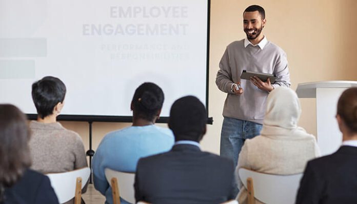 Employee engagement session during effective employee training with a speaker presenting to a group