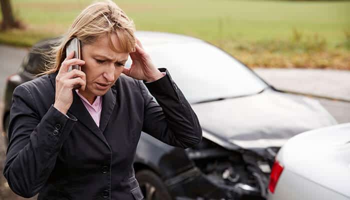 When to Talk to a Car Accident Attorney - Startupeditor | Startup Editor Distressed woman standing near a damaged car while speaking on the phone after a collision, highlighting real-world accident aftermath and the urgent need for Car Accident Attorneys to provide legal guidance, insurance claim support, and injury compensation assistance following roadway incidents and vehicle crashes.