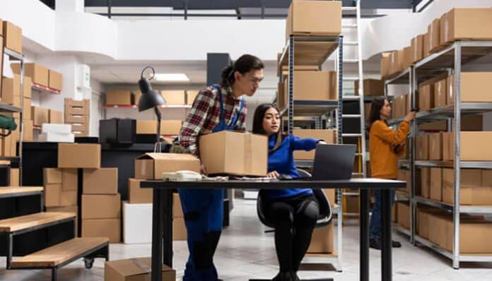 Custom Packaging and Fulfillment Services in a modern e-commerce warehouse where trained staff manage order processing, product packing, and inventory coordination using digital systems and organized shelving to ensure efficient and accurate fulfillment workflows for online businesses.