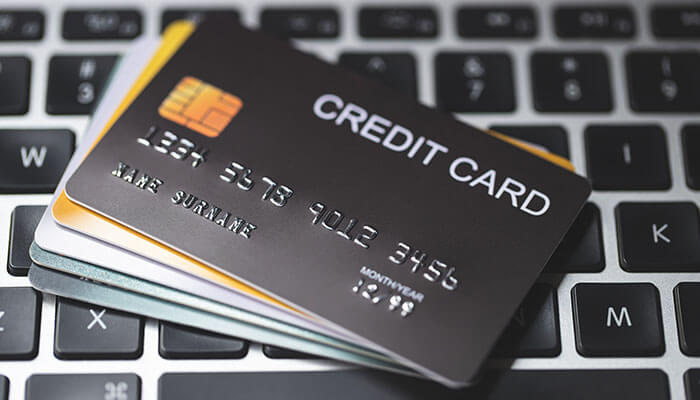 How Credit Limits Work for Startup Business Credit Cards - Startupeditor | Startup Editor Startup Business Credit Cards With No Credit concept showing multiple credit cards on laptop keyboard representing startup financing and business credit building