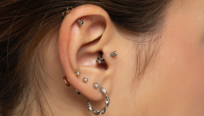Potential Risks Associated With Extreme Facial Piercings - Startupeditor | Startup Editor Multiple ear piercings example related to what is a lobotomy piercing body art