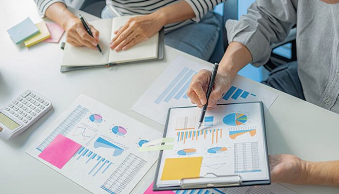 Startup consulting session with consultants analyzing business growth charts and strategy reports
