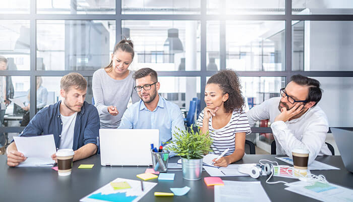 Startup Marketing Agency - Startupeditor | Startup Editor Startup marketing agency team collaborating on digital marketing strategy in office