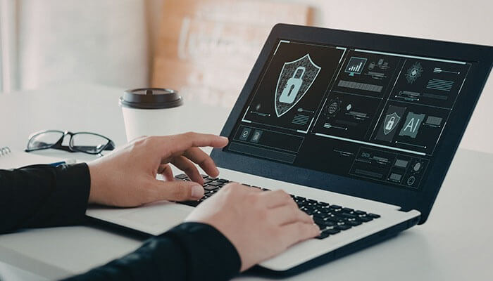 Cybersecurity and Digital Trust - Startup editor | Startup Editor A person using a laptop displaying cybersecurity and digital trust analytics, with a lock symbol highlighting Droven.io Enterprise Tech Innovation in AI, data protection, and enterprise security.