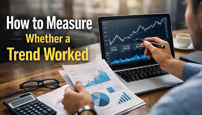 How to Measure Whether a Trend Worked - Startup editor | Startup Editor Professional analyzing charts and graphs on laptop and paper to understand performance metrics, illustrating what are social media trends? and their impact on audience engagement and digital marketing strategies in 2026.
