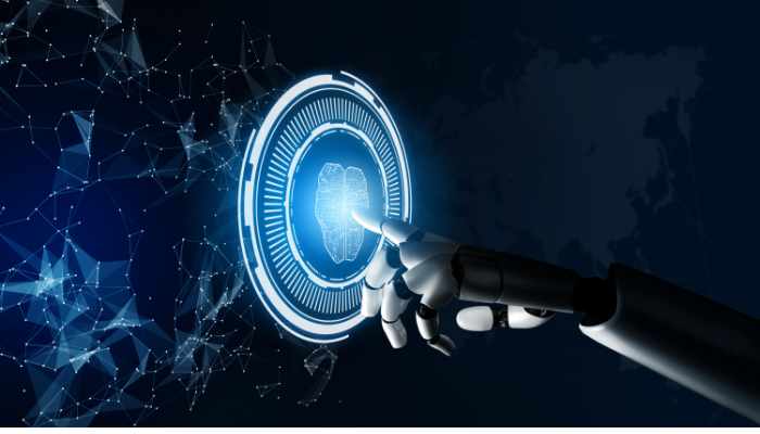 Intelligent Automation | Startup Editor Robotic hand touching a glowing circular digital interface in a dark tech background.