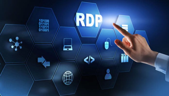 Hand tapping a glowing hexagon labeled 'RDP' on a futuristic tech interface, representing remote desktop technology.