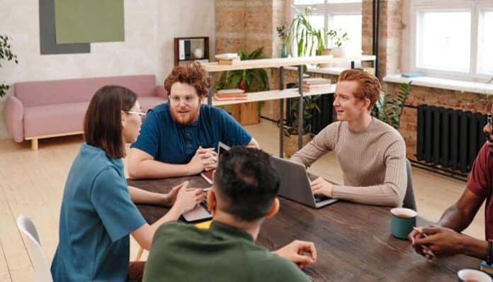 Startup Investors observing a collaborative startup pitch discussion in a modern office environment, where diverse founders engage in strategic planning and product validation, reflecting how Startup Investors evaluate team dynamics, communication clarity, and early-stage business potential during investment decision-making.