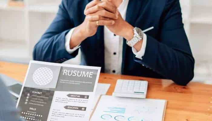 Why Business Systems Analyst Keywords Matter for ATS - Startup Editor | Startup Editor Business Systems Analyst Resume Keywords represented by a professional reviewing a resume with skills, education, and experience sections for an ATS-friendly application.