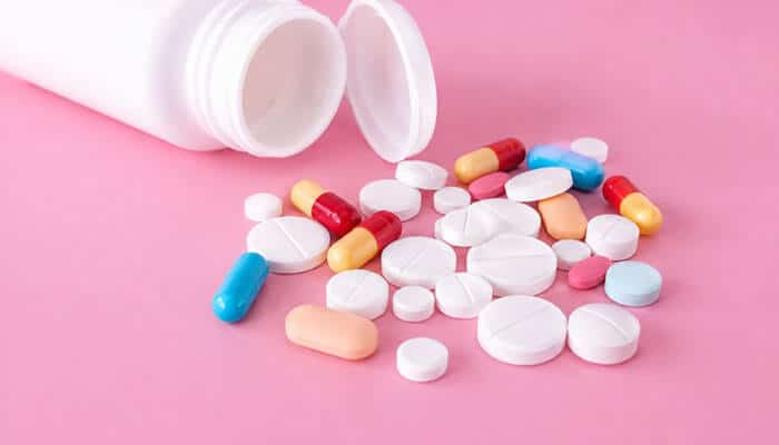 How Long Does the BI 8 White Pill Take to Work? - Startup Editor | Startup Editor BI 8 White Pill medication concept showing assorted tablets and capsules beside an open medicine bottle for prescription drug safety awareness.