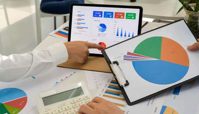 How to Value a Startup Step by Step - Startup Editor | Startup Editor Startup Valuation process with business analysts reviewing revenue charts, market data, and financial metrics to estimate a company's investment value