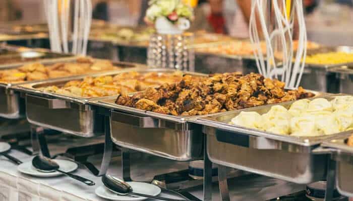 Save on Catering Without Making the Event Feel Cheap - Startup Editor | Startup Editor Start ThriftyEvents.net catering strategy featuring a buffet setup that illustrates food planning, guest-count control, and event costs.