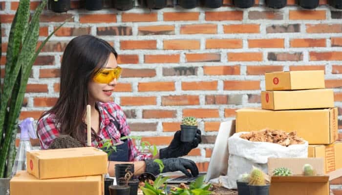 Buy From Local Businesses When It Makes Sense - Startup Editor | Startup Editor Best Ways to Support Local Businesses by showcasing a small business owner preparing products, managing orders, and building a community-focused brand.