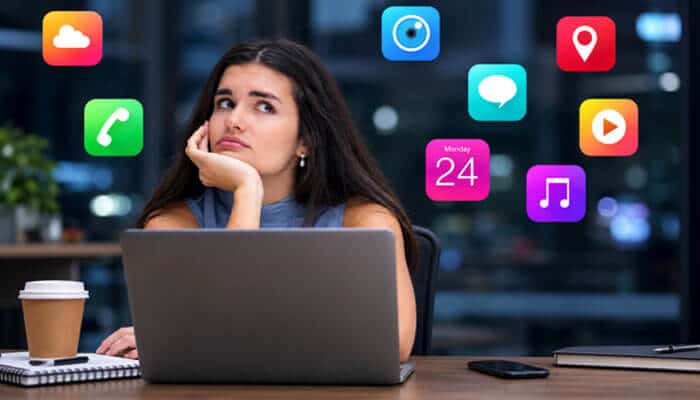 Should You Connect Social Accounts to AlienSync? - Startup Editor | Startup Editor Socials and Softwares AlienSync concept showing a laptop user surrounded by multiple app icons, representing fragmented software and social media management.