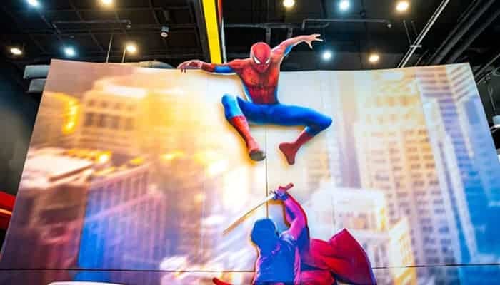 How Spiderman Brand New Day Sets Up the X-Men - Startupeditor | Startup Editor Spiderman Brand New Day exhibition display showing Spider-Man in an action pose over a large city-themed screen.