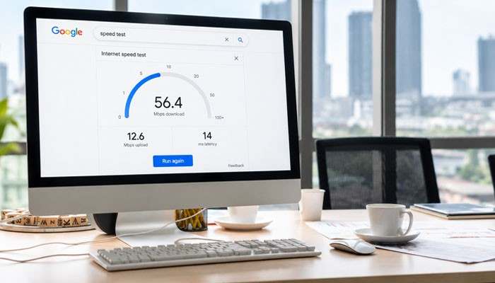 Why Is My Google Speed Test Slower Than My Internet Plan? - Startup Editor | Startup Editor Google Speed Test results on an office computer showing 56.4 Mbps download speed, 12.6 Mbps upload speed, and 14 ms latency.