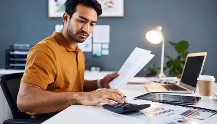How to Dispute a Midland Credit Management Account - Startup Editor | Startup Editor Midland Credit Management financial planning concept showing a consumer reviewing bills and calculating payments to manage debt obligations and credit concerns.