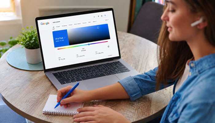 How to Open Google Color Picker - Startup Editor | Startup Editor Designer using Google Color Picker on a laptop to choose a blue shade and review its HEX, RGB, HSV, HSL, and CMYK color values.