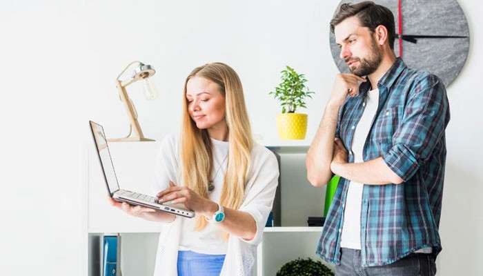 What Do You Need Before You Build a Squarespace Website? - Startup Editor | Startup Editor Squarespace Build a Website process with business professionals reviewing website design ideas, page layouts, branding elements, and digital growth strategies on a laptop.