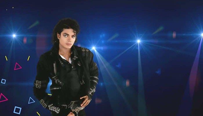 Why Do People Question Whether Michael Jackson Was the Biological Father? - Startup Editor | Startup Editor Does Michael Jackson Have Any Biological Children? Michael Jackson in a black stage outfit against a blue concert-light background.