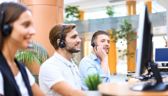 Why Are There So Many BHN Customer Service Numbers? - Startup Editor | Startup Editor BHN Customer Service call center agents wearing headsets and assisting customers with support requests from office workstations.