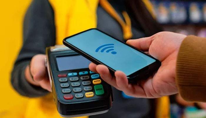 How to Make a Contactless Payment - Startup Editor | Startup Editor Contactless Payment with an NFC-enabled smartphone held over a point-of-sale terminal for a quick tap-to-pay transaction.