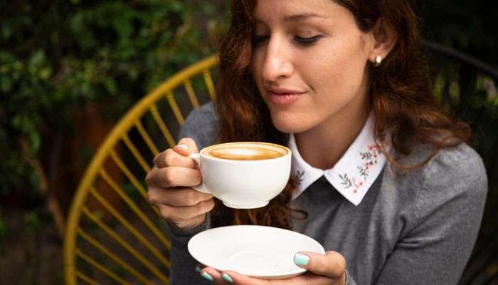 San Fernando Coffee Company Rewards Program - Startup Editor | Startup Editor Woman enjoying a hot cup of coffee, representing the café experience discussed in this San Fernando Coffee Company guide.