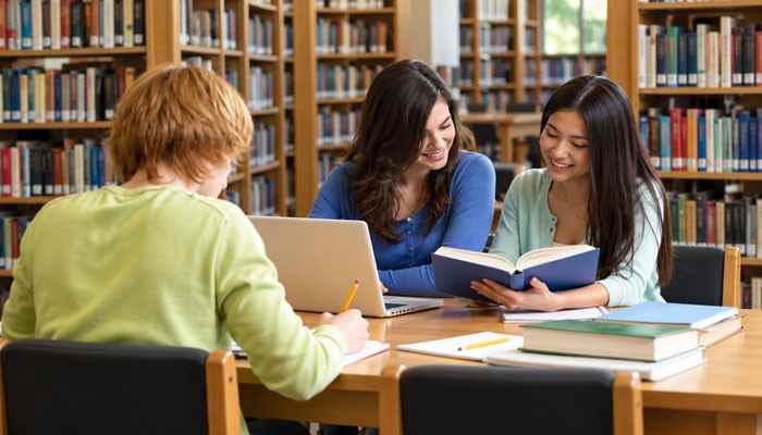 What Documents Are Required for a Library Card? - Startup Editor | Startup Editor Local Library Card Application resources in a public library where students use books and a laptop for study, research, learning, and digital library access.