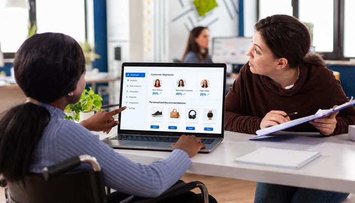 How to Choose Personalization and Behavioral Targeting Software - Startup Editor | Startup Editor Two professionals reviewing Personalization and Behavioral Targeting Software with customer segments, audience analytics, and product recommendations.