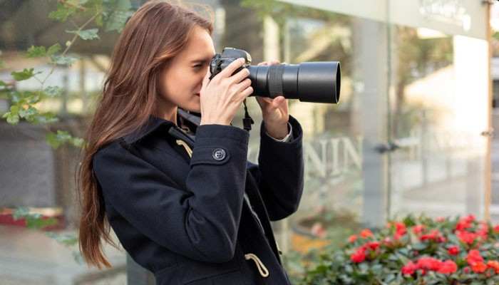 Why Telephoto Lenses Need Extra Care - Startup Editor | Startup Editor How to Fix Shaky Hands Photography by holding a camera securely with both hands while using a telephoto lens to improve stability and reduce camera shake.